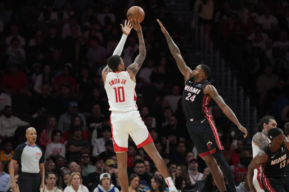 Mar 21, 2025; Miami, Florida, USA;  Houston Rockets forward Jabari Smith Jr. (10) shoots over Miami Heat forward Haywood Highsmith (24) in the second half at Kaseya Center. Mandatory Credit: Jim Rassol-Imagn Images