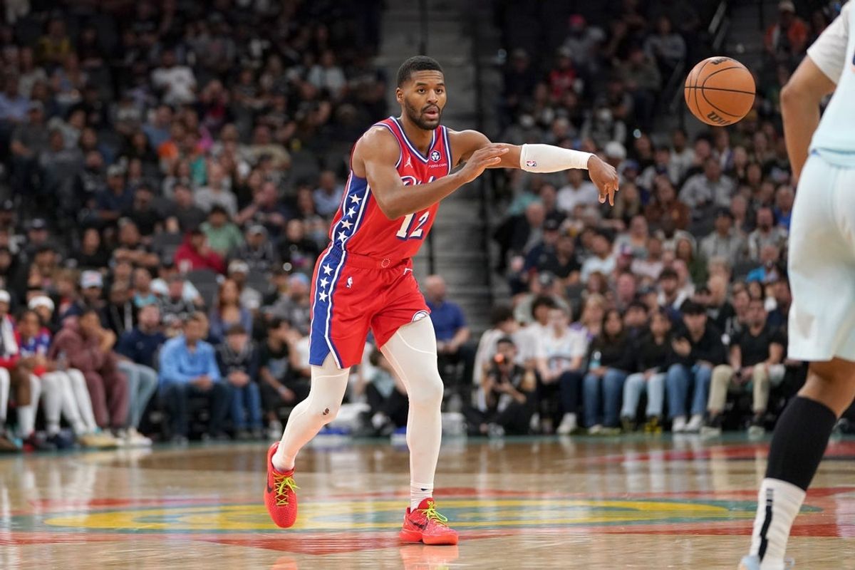 Mar 21, 2025; San Antonio, Texas, USA; Philadelphia 76ers guard Jared Butler (12) passes during the fourth quarter against the San Antonio Spurs at Frost Bank Center. Mandatory Credit: Dustin Safranek-Imagn Images