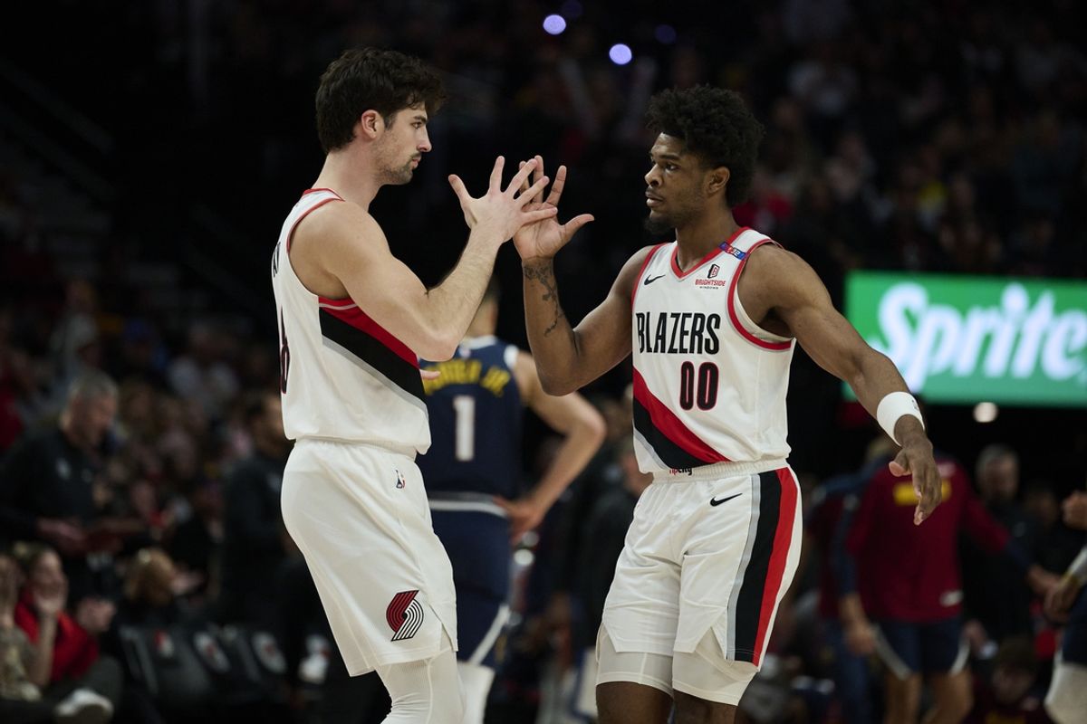 Mar 21, 2025; Portland, Oregon, USA; Portland Trail Blazers forward Deni Avdija (8) and guard Scoot Henderson (00) celebrate during the second half against the Denver Nuggets at Moda Center. Mandatory Credit: Troy Wayrynen-Imagn Images