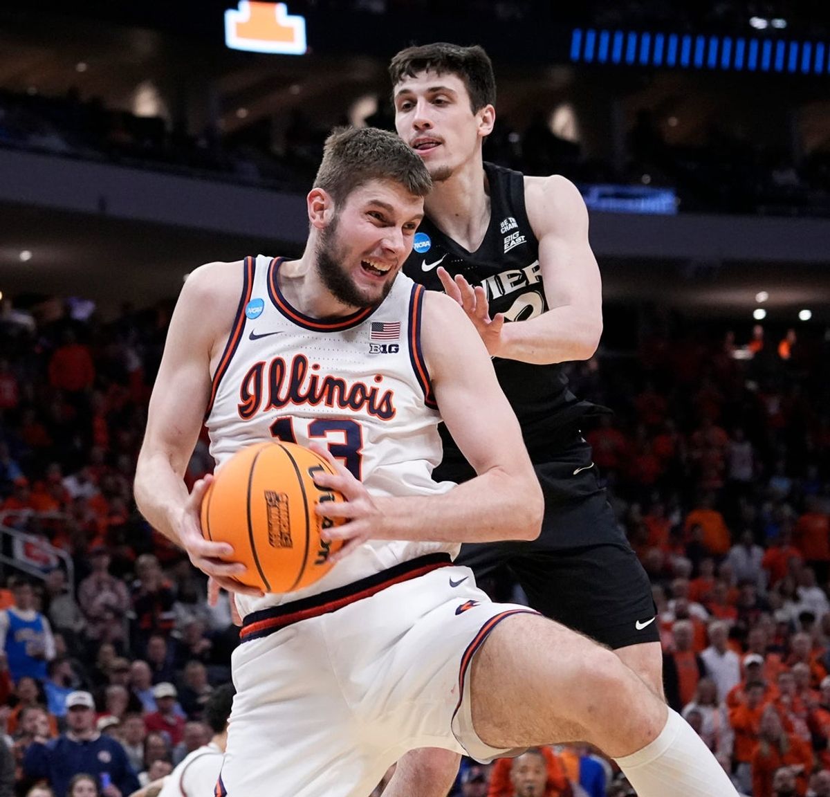 Illinois center Tomislav Ivisic (13) beats Xavier forward Zach Freemantle (32) to the rebound during the second half of their first round NCAA men’ s basketball tournament game on Friday March 21, 2025 at Fiserv Forum in Milwaukee, Wis.