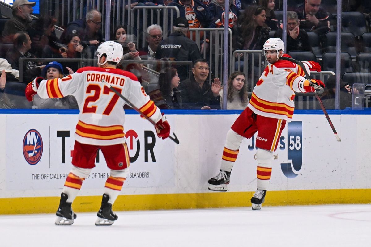 Mar 22, 2025; Elmont, New York, USA;  Calgary Flames center Nazem Kadri (91) Celebrates his game winning goal against the New York Islanders during the overtime period at UBS Arena. Mandatory Credit: Dennis Schneidler-Imagn Images