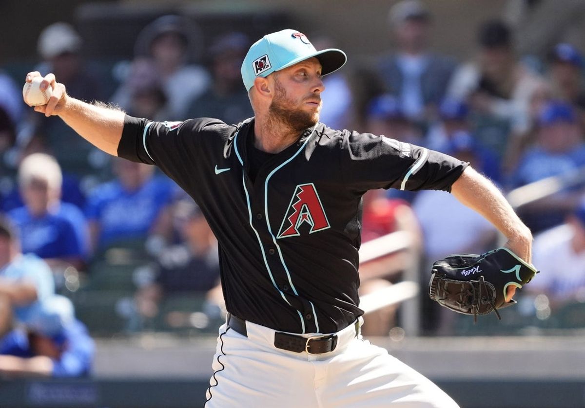 Arizona Diamondbacks starting pitcher Merrill Kelly throws to the Kansas City Royals in the third inning during a spring training game at Salt River Fields at Talking Stick on March 11, 2025.