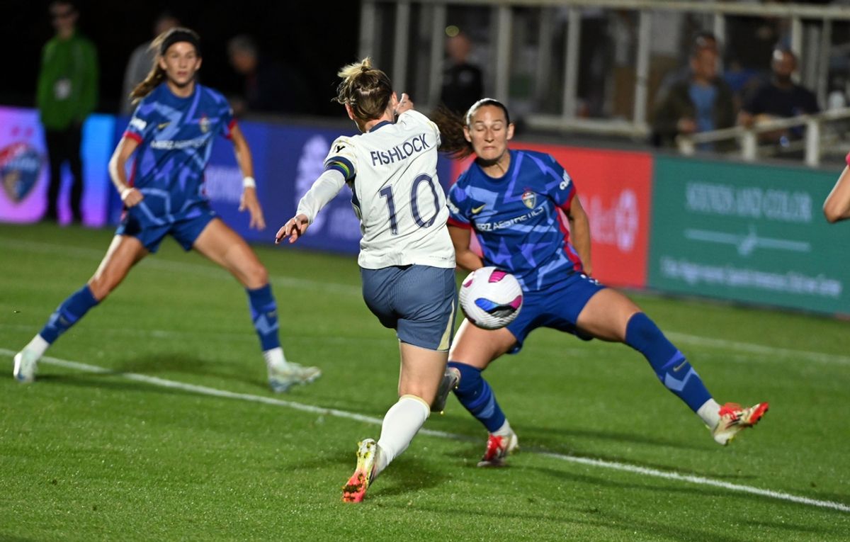 Mar 22, 2025; Cary, North Carolina, USA; Seattle Reign midfielder Jessica Fishlock (10) shoots past North Carolina Courage defender Kaleigh Kurtz (3) during the first half at First Horizon Stadium at WakeMed Soccer Park. Mandatory Credit: Rob Kinnan-Imagn Images