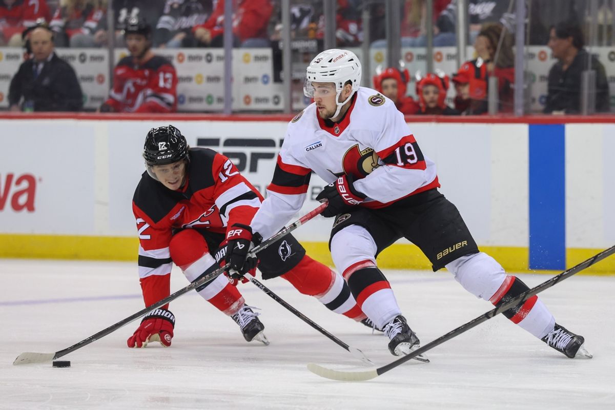 Mar 22, 2025; Newark, New Jersey, USA; Ottawa Senators right wing Drake Batherson (19) skates with the puck as New Jersey Devils center Cody Glass (12) defends during the first period at Prudential Center. Mandatory Credit: Ed Mulholland-Imagn Images