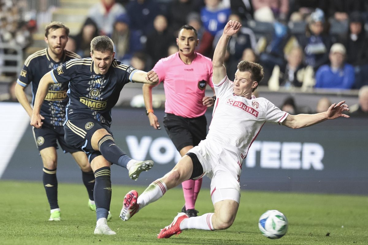 Mar 22, 2025; Chester, Pennsylvania, USA; Philadelphia Union forward Mikael Uhre (7) shoots the ball as St. Louis CITY SC midfielder Christopher Durbin (8) defends during the first half at Subaru Park. Mandatory Credit: Luther Schlaifer-Imagn Images