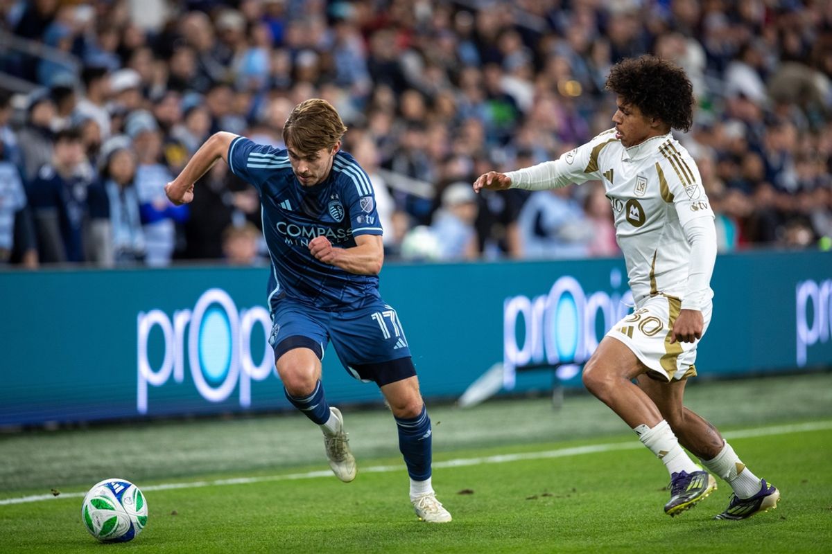 Mar 22, 2025; Kansas City, Kansas, USA; Sporting Kansas City forward Khiry Shelton (11) attempts to get past Los Angeles FC forward David Martinez (30) during the first half of the match at Children's Mercy Park. Mandatory Credit: Kylie Graham-Imagn Images