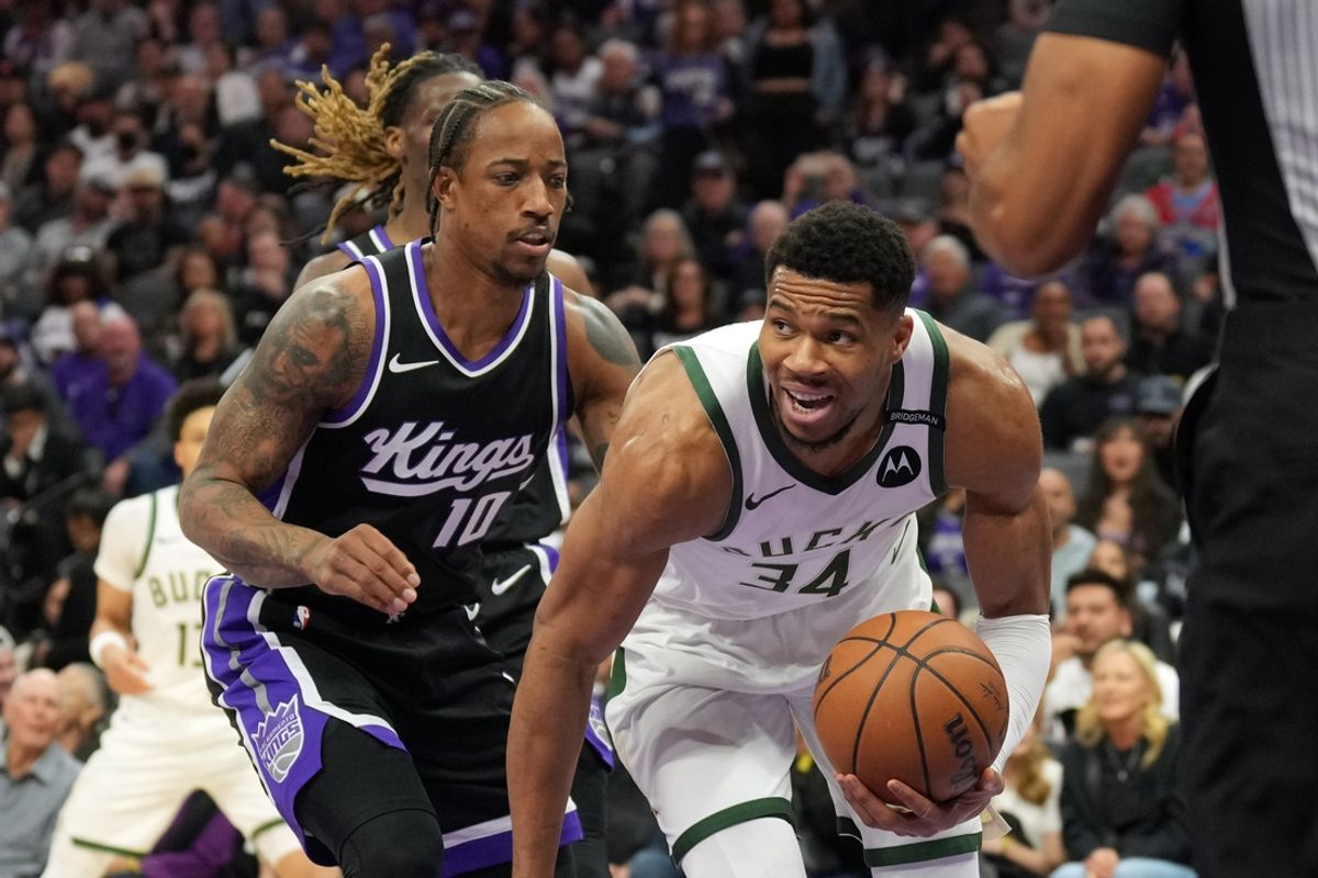 Mar 22, 2025; Sacramento, California, USA; Milwaukee Bucks forward Giannis Antetokounmpo (34) dribbles against Sacramento Kings forward DeMar DeRozan (10) during the first quarter at Golden 1 Center. Mandatory Credit: Darren Yamashita-Imagn Images