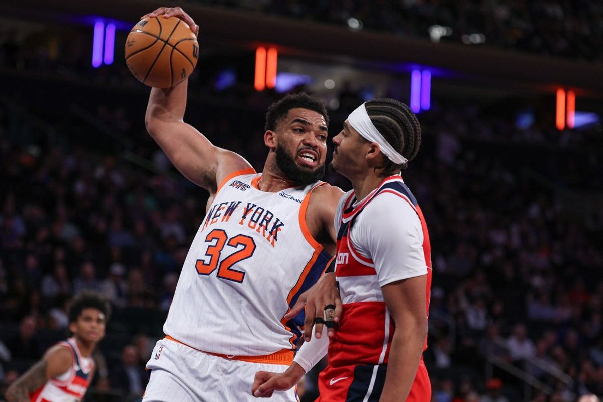 Mar 22, 2025; New York, New York, USA; New York Knicks center Karl-Anthony Towns (32) is fouled by Washington Wizards guard Jordan Poole (13) while rebounding during the second half at Madison Square Garden. Mandatory Credit: Vincent Carchietta-Imagn Images