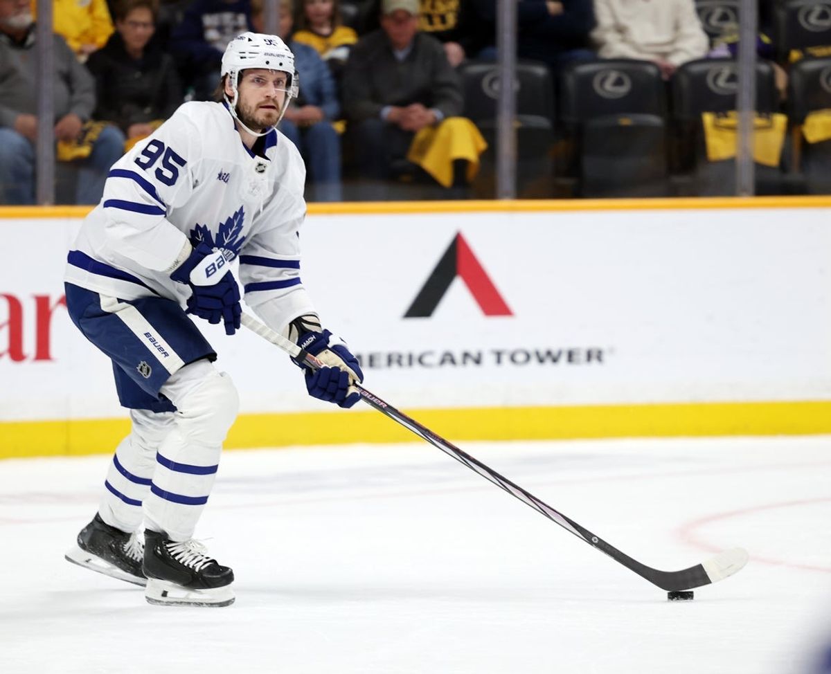 Mar 22, 2025; Nashville, Tennessee, USA; Toronto Maple Leafs defenseman Oliver Ekman-Larsson (95) looks to pass the puck during the first period of the game against the Nashville Predators at Bridgestone Arena. Mandatory Credit: Alan Poizner-Imagn Images