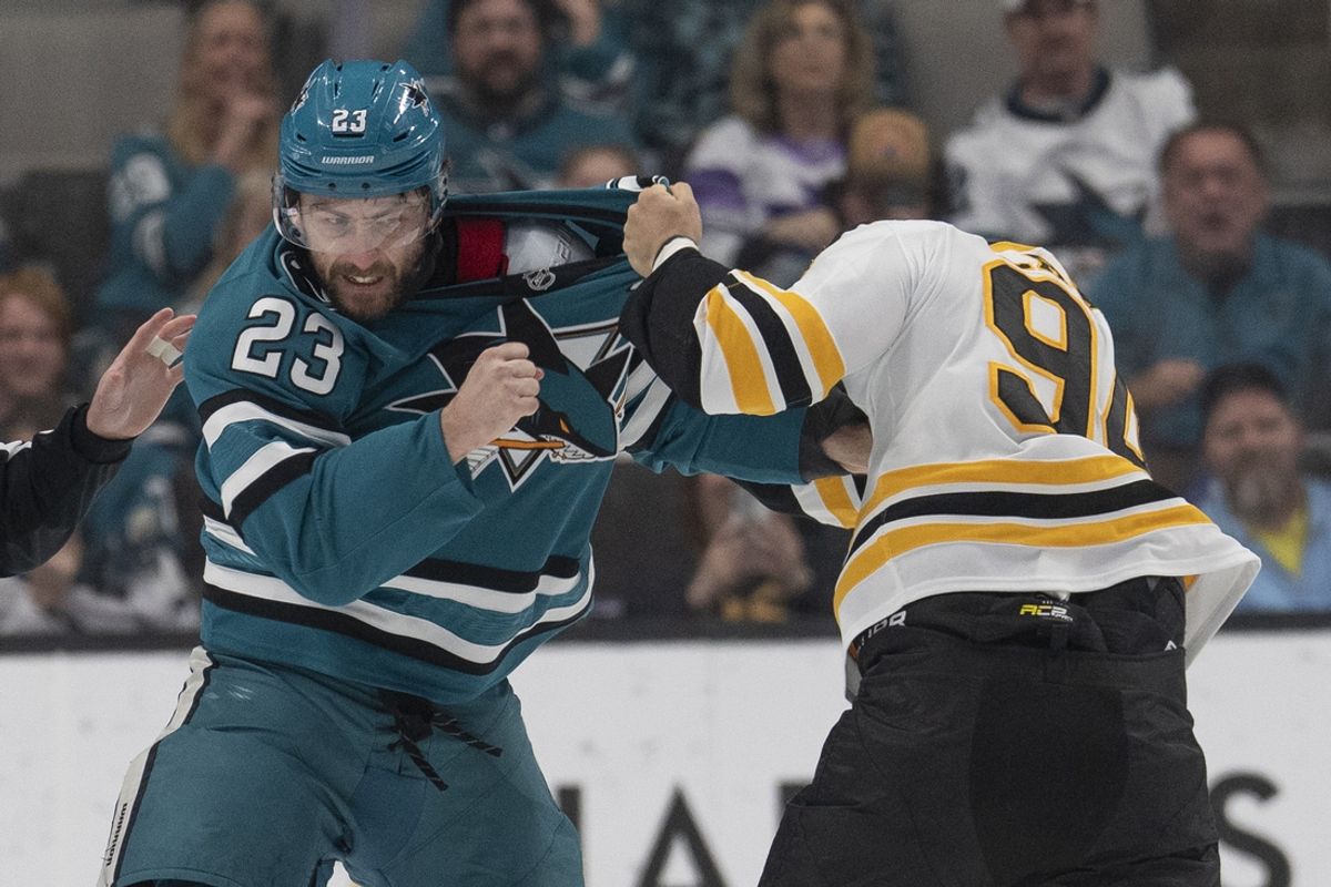 Mar 22, 2025; San Jose, California, USA;  San Jose Sharks right wing Barclay Goodrow (23) and Boston Bruins center Jakub Lauko (94) fight during the first period at SAP Center at San Jose. Mandatory Credit: Stan Szeto-Imagn Images