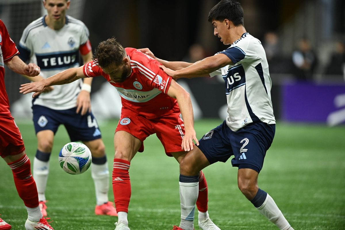 Mar 22, 2025; Vancouver, British Columbia, CAN;  Chicago Fire FC forward Philip Zinckernagel (11) battles for the ball against Vancouver Whitecaps FC defender Mathias Laborda (2) during the first half at BC Place. Mandatory Credit: Anne-Marie Sorvin-Imagn Images