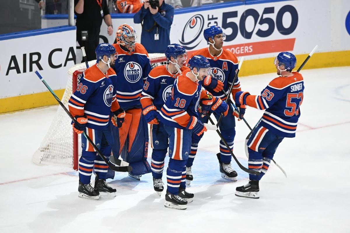 Mar 22, 2025; Edmonton, Alberta, CAN;   Edmonton Oilers defenceman Jake Walman (96) celebrates their win with  Oilers goalie Stuart Skinner (74) Oilers centre Ryan Nugent-Hopkins (93) and Oilers left winger Zach Hyman (18) during the third period at Rogers Place. Mandatory Credit: Walter Tychnowicz-Imagn Images