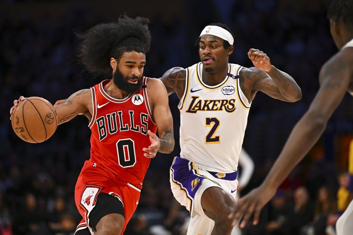 Mar 22, 2025; Los Angeles, California, USA; Chicago Bulls guard Coby White (0) drives the ball against Los Angeles Lakers forward Jarred Vanderbilt (2) during the second half at Crypto.com Arena. Mandatory Credit: Jonathan Hui-Imagn Images