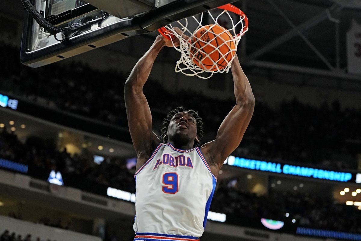 Mar 23, 2025; Raleigh, NC, USA; Florida Gators center Rueben Chinyelu (9) dunks the ball during the second half against the Connecticut Huskies in the second round of the NCAA Tournament at Lenovo Center. Mandatory Credit: Bob Donnan-Imagn Images