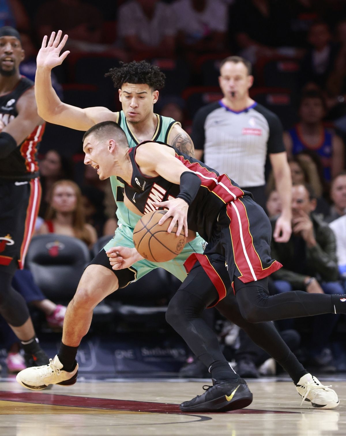 Mar 23, 2025; Miami, Florida, USA;  Charlotte Hornets guard KJ Simpson (25) defends Miami Heat guard Tyler Herro (14)during the first half at Kaseya Center. Mandatory Credit: Rhona Wise-Imagn Images