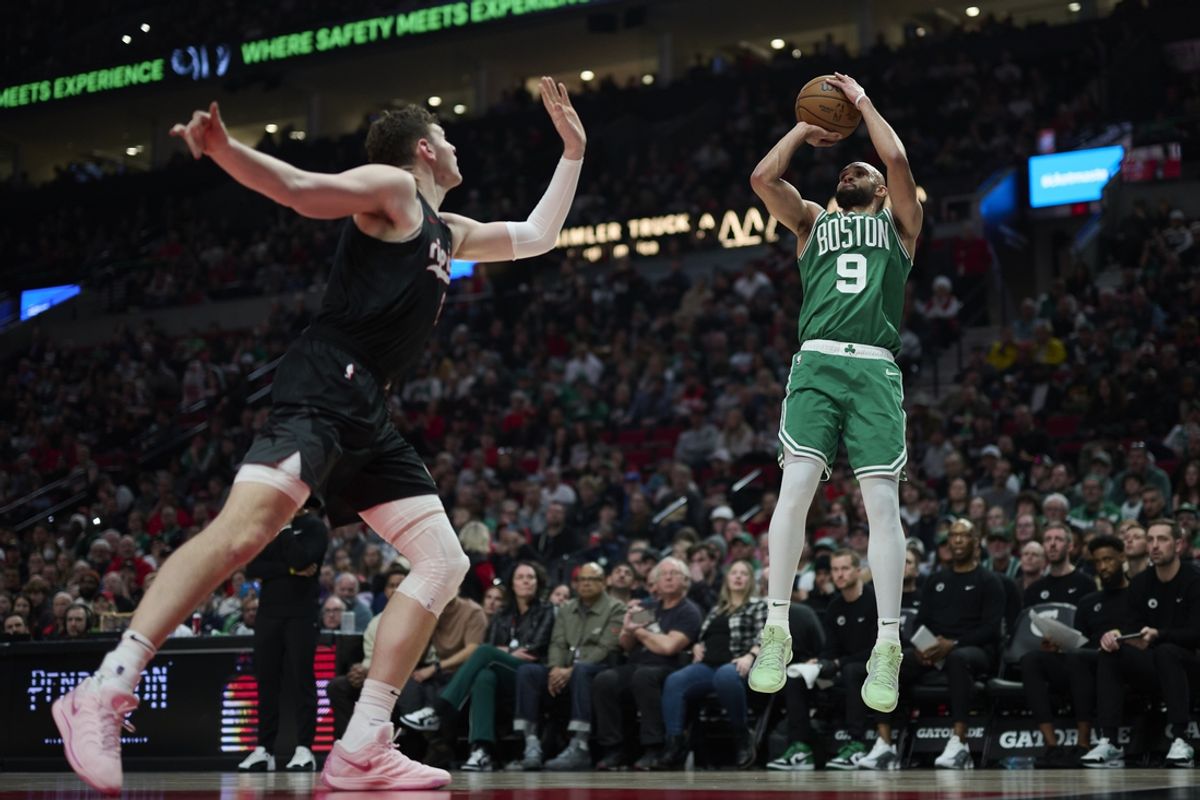 Mar 23, 2025; Portland, Oregon, USA; Boston Celtics guard Derrick White (9) shoots a jump shot during the first half against Portland Trail Blazers center Donovan Clingan (23) at Moda Center. Mandatory Credit: Troy Wayrynen-Imagn Images