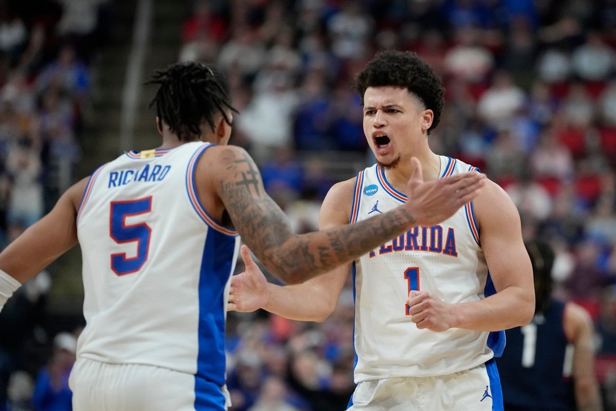 Mar 23, 2025; Raleigh, NC, USA; Florida Gators guard Walter Clayton Jr. (1) reacts with guard Will Richard (5) in the second half at Lenovo Center. Mandatory Credit: Bob Donnan-Imagn Images