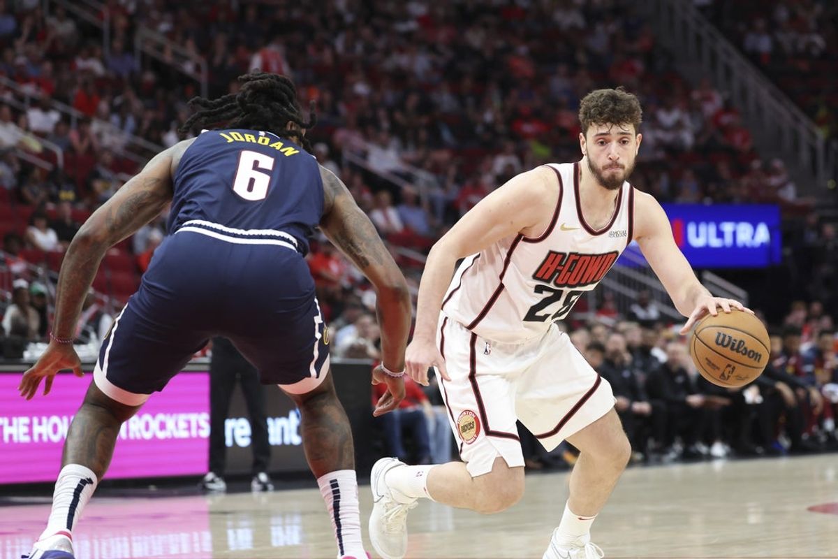 Mar 23, 2025; Houston, Texas, USA; Houston Rockets center Alperen Sengun (28) dribbles the ball as Denver Nuggets center DeAndre Jordan (6) defends during the first quarter at Toyota Center. Mandatory Credit: Troy Taormina-Imagn Images