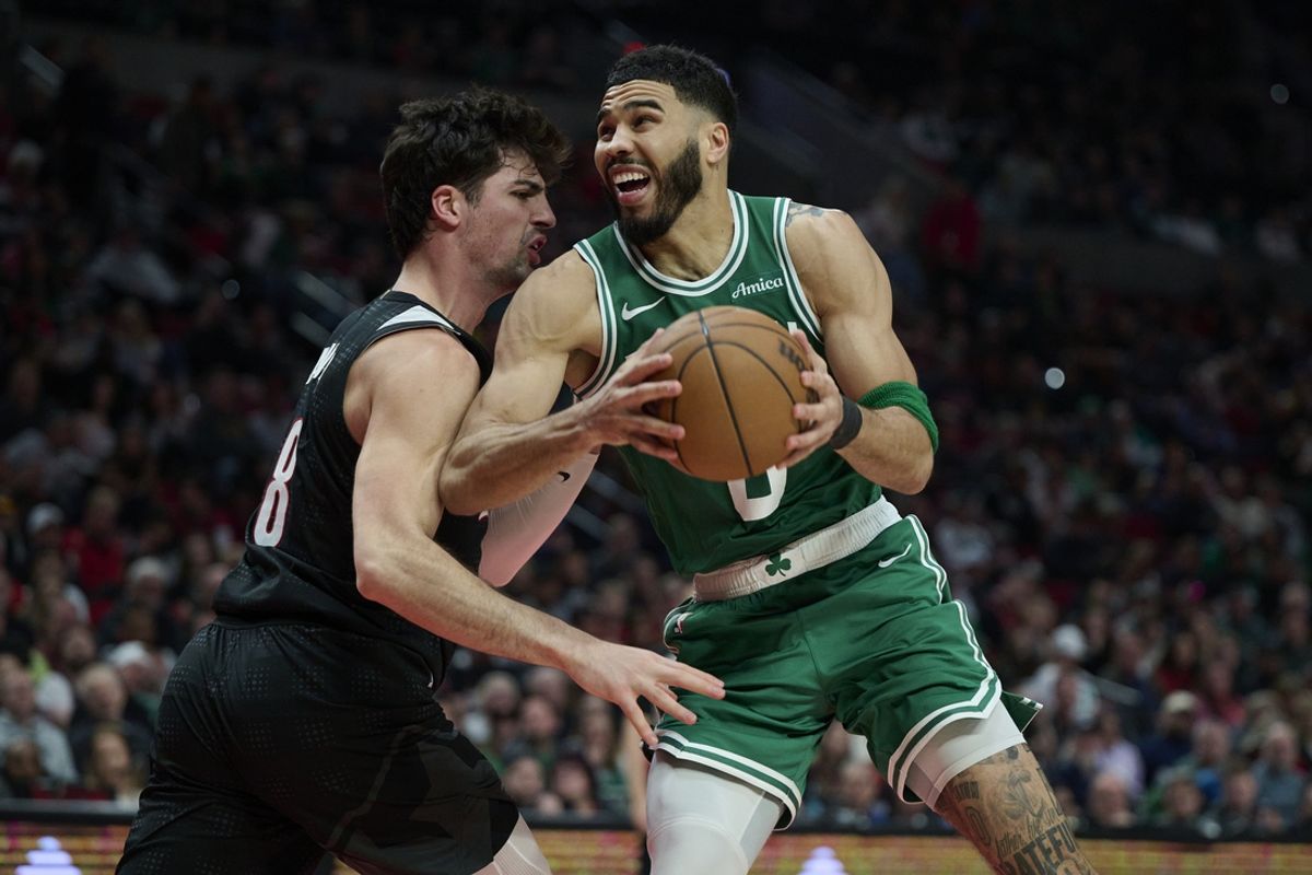 Mar 23, 2025; Portland, Oregon, USA; Boston Celtics forward Jayson Tatum (0) drives to the basket during the second half against Portland Trail Blazers forward Deni Avdija (8) at Moda Center. Mandatory Credit: Troy Wayrynen-Imagn Images