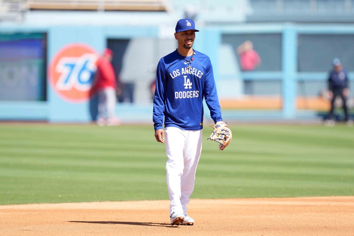 Mar 23, 2025; Los Angeles, California, USA; Los Angeles Dodgers shortstop Mookie Betts warms up before the game against the Los Angeles Angels at Dodger Stadium. Mandatory Credit: Kirby Lee-Imagn Images