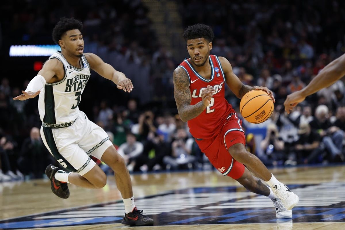 Mar 23, 2025; Cleveland, OH, USA; New Mexico Lobos guard Donovan Dent (2) dribbles in the second half against the Michigan State Spartans during the NCAA Tournament Second Round at Rocket Arena. Mandatory Credit: Rick Osentoski-Imagn Images