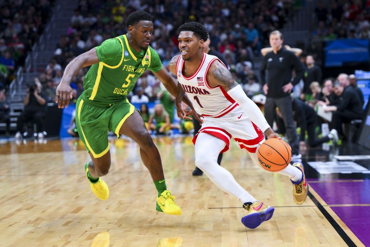 Mar 23, 2025; Seattle, WA, USA;  Arizona Wildcats guard Caleb Love (1) dribbles the ball against Oregon Ducks guard TJ Bamba (5) in the second half at Climate Pledge Arena. Mandatory Credit: Steven Bisig-Imagn Images