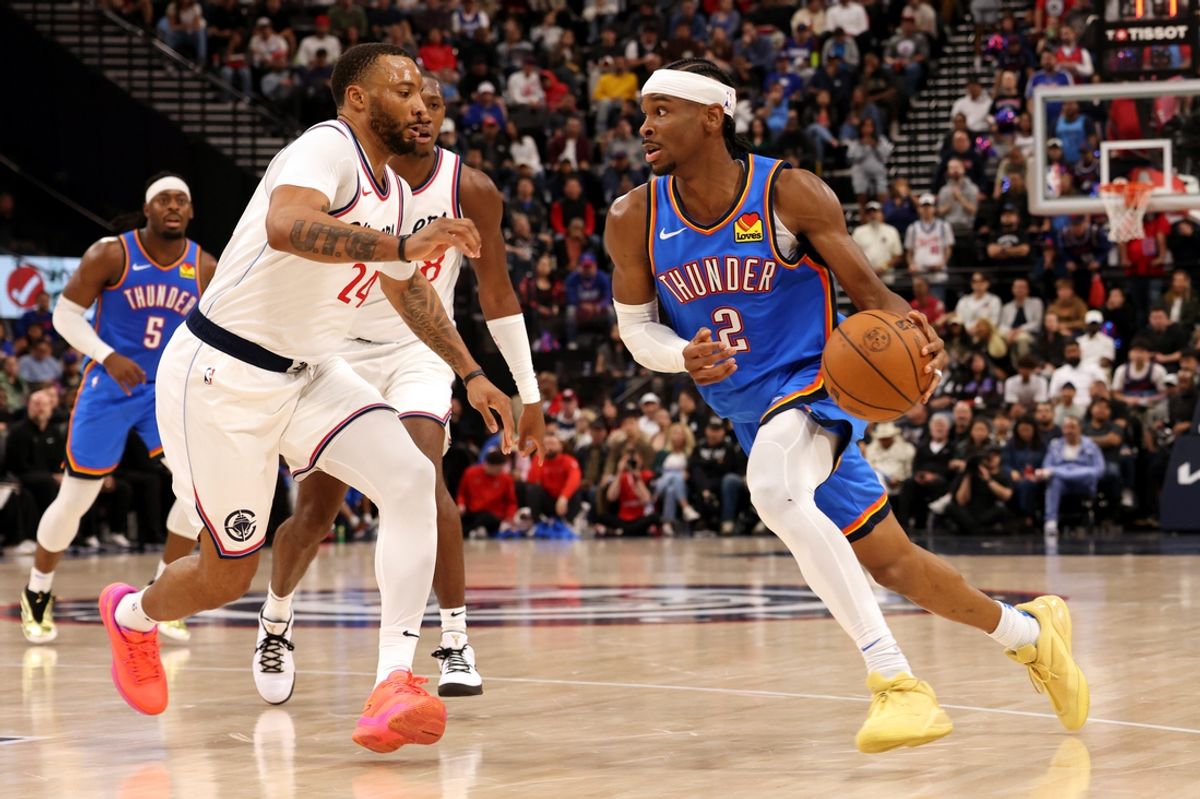 Mar 23, 2025; Inglewood, California, USA; Oklahoma City Thunder guard Shai Gilgeous-Alexander (2) drives against LA Clippers guard Norman Powell (24) during the 3rd quarter at Intuit Dome. Mandatory Credit: Jason Parkhurst-Imagn Images