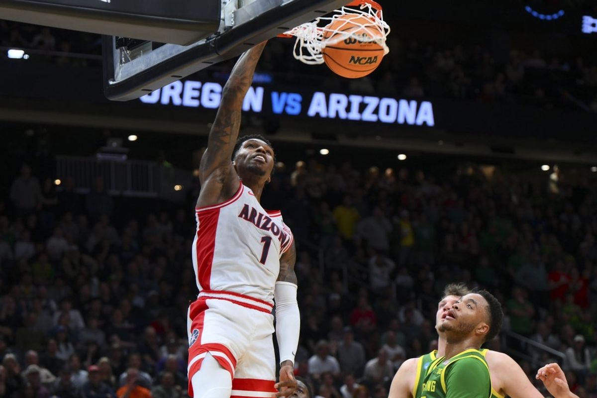 Mar 23, 2025; Seattle, WA, USA;  Arizona Wildcats guard Caleb Love (1) dunks the ball against the Oregon Ducks in the second half at Climate Pledge Arena. Mandatory Credit: Steven Bisig-Imagn Images