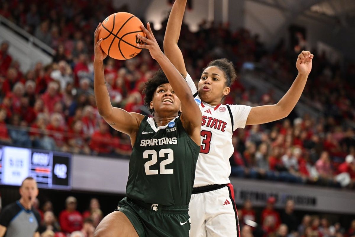 Mar 24, 2025; Raleigh, North Carolina, USA; Michigan State Spartans guard Nyla Hampton (22) shoots against NC State Wolfpack guard Zamareya Jones (3) during the second half at James T. Valvano Arena at William Neal Reynolds. Mandatory Credit: William Howard-Imagn Images