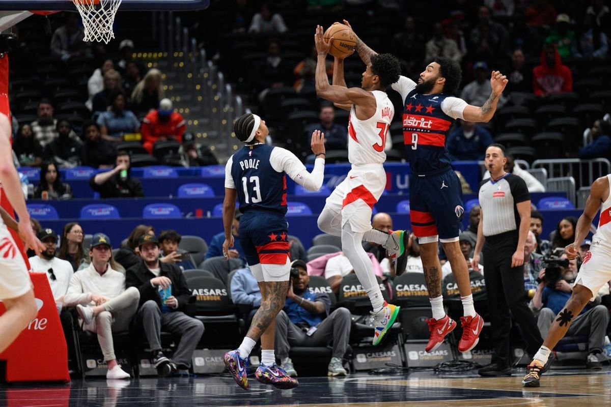 Mar 24, 2025; Washington, District of Columbia, USA; Washington Wizards forward Justin Champagnie (9) blocks Toronto Raptors guard Ochai Agbaji (30) during the second quarter at Capital One Arena. Mandatory Credit: Reggie Hildred-Imagn Images