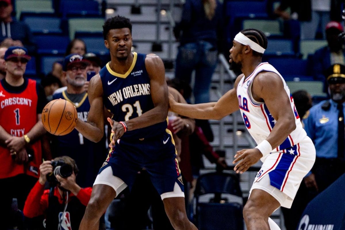 Mar 24, 2025; New Orleans, Louisiana, USA;  New Orleans Pelicans center Yves Missi (21) passes the ball around Philadelphia 76ers forward Chuma Okeke (18) during the first half at Smoothie King Center. Mandatory Credit: Stephen Lew-Imagn Images