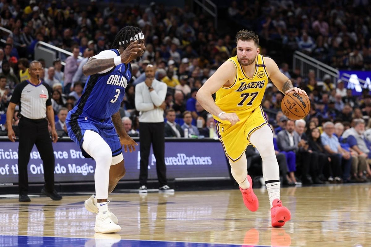 Mar 24, 2025; Orlando, Florida, USA; Los Angeles Lakers guard Luka Doncic (77) drives to the basket against the Orlando Magic in the second quarter at Kia Center. Mandatory Credit: Nathan Ray Seebeck-Imagn Images