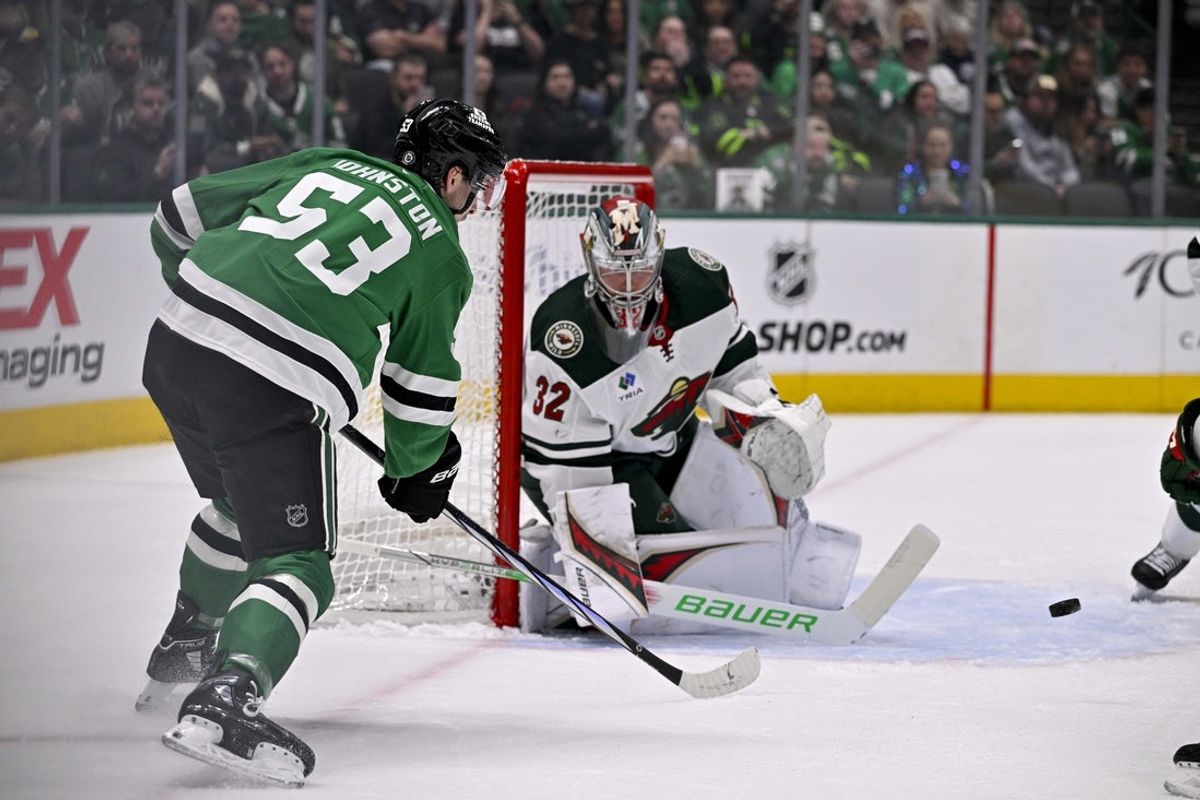 Mar 24, 2025; Dallas, Texas, USA; Minnesota Wild goaltender Filip Gustavsson (32) stops a shot by Dallas Stars center Wyatt Johnston (53) during the second period at the American Airlines Center. Mandatory Credit: Jerome Miron-Imagn Images