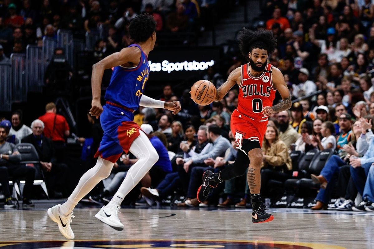 Mar 24, 2025; Denver, Colorado, USA; Chicago Bulls guard Coby White (0) dribbles the ball up court against Denver Nuggets forward Peyton Watson (8) in the second quarter at Ball Arena. Mandatory Credit: Isaiah J. Downing-Imagn Images