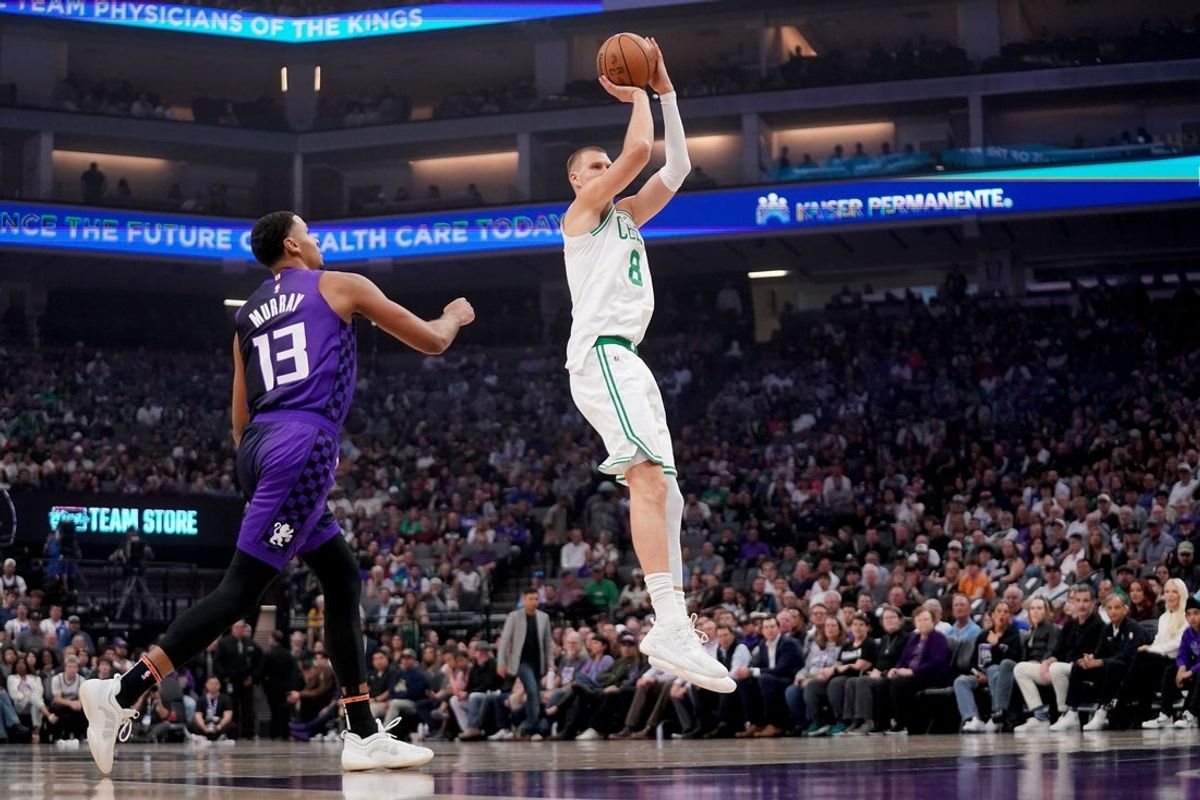 Mar 24, 2025; Sacramento, California, USA; Boston Celtics forward Kristaps Porzingis (8) shoots over Sacramento Kings forward Keegan Murray (13) in the first quarter at the Golden 1 Center. Mandatory Credit: Cary Edmondson-Imagn Images