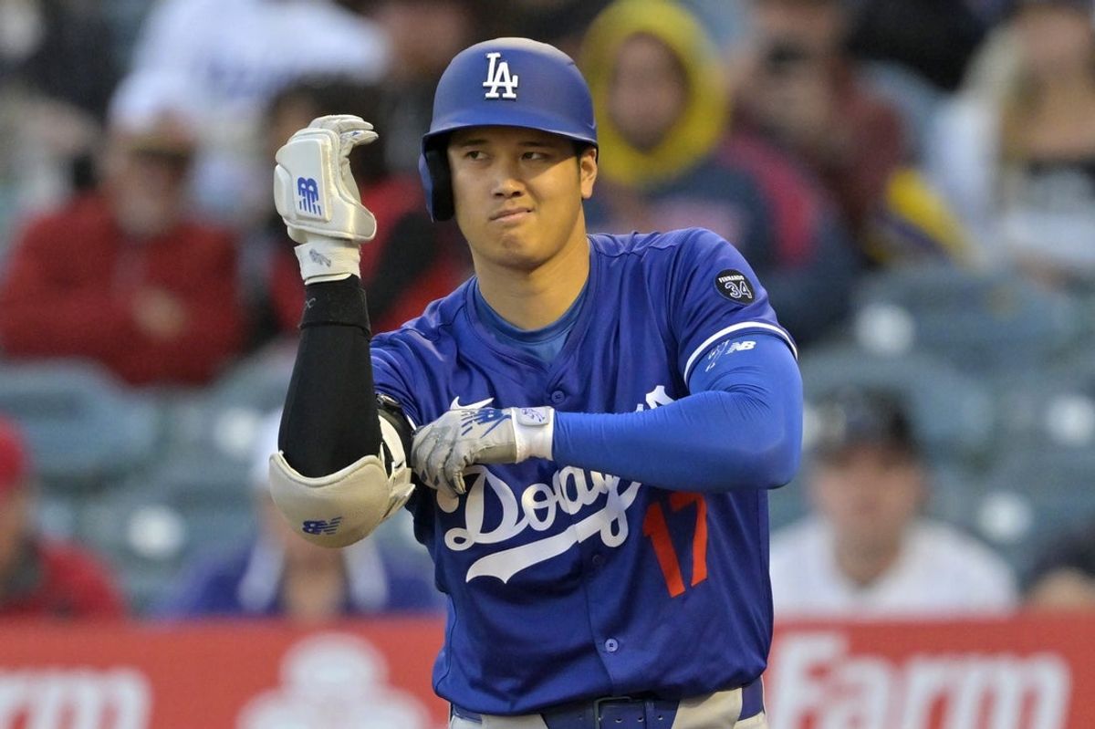 Mar 24, 2025; Anaheim, California, USA;  Los Angeles Dodgers designated hitter Shohei Ohtani (17) adjusts his elbow bad during his at bat in the second inning against the Los Angeles Angels at Angel Stadium. Mandatory Credit: Jayne Kamin-Oncea-Imagn Images