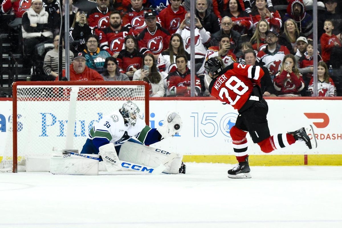 Mar 24, 2025; Newark, New Jersey, USA; Vancouver Canucks goaltender Thatcher Demko (35) makes a save against New Jersey Devils right wing Timo Meier (28) during overtime shootouts at Prudential Center. Mandatory Credit: John Jones-Imagn Images