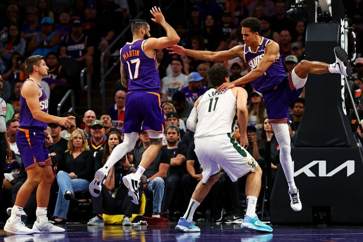Mar 24, 2025; Phoenix, Arizona, USA; Milwaukee Bucks center Brook Lopez (11) shoots the ball against Phoenix Suns center Oso Ighodaro (4) during the second quarter at Footprint Center. Mandatory Credit: Mark J. Rebilas-Imagn Images