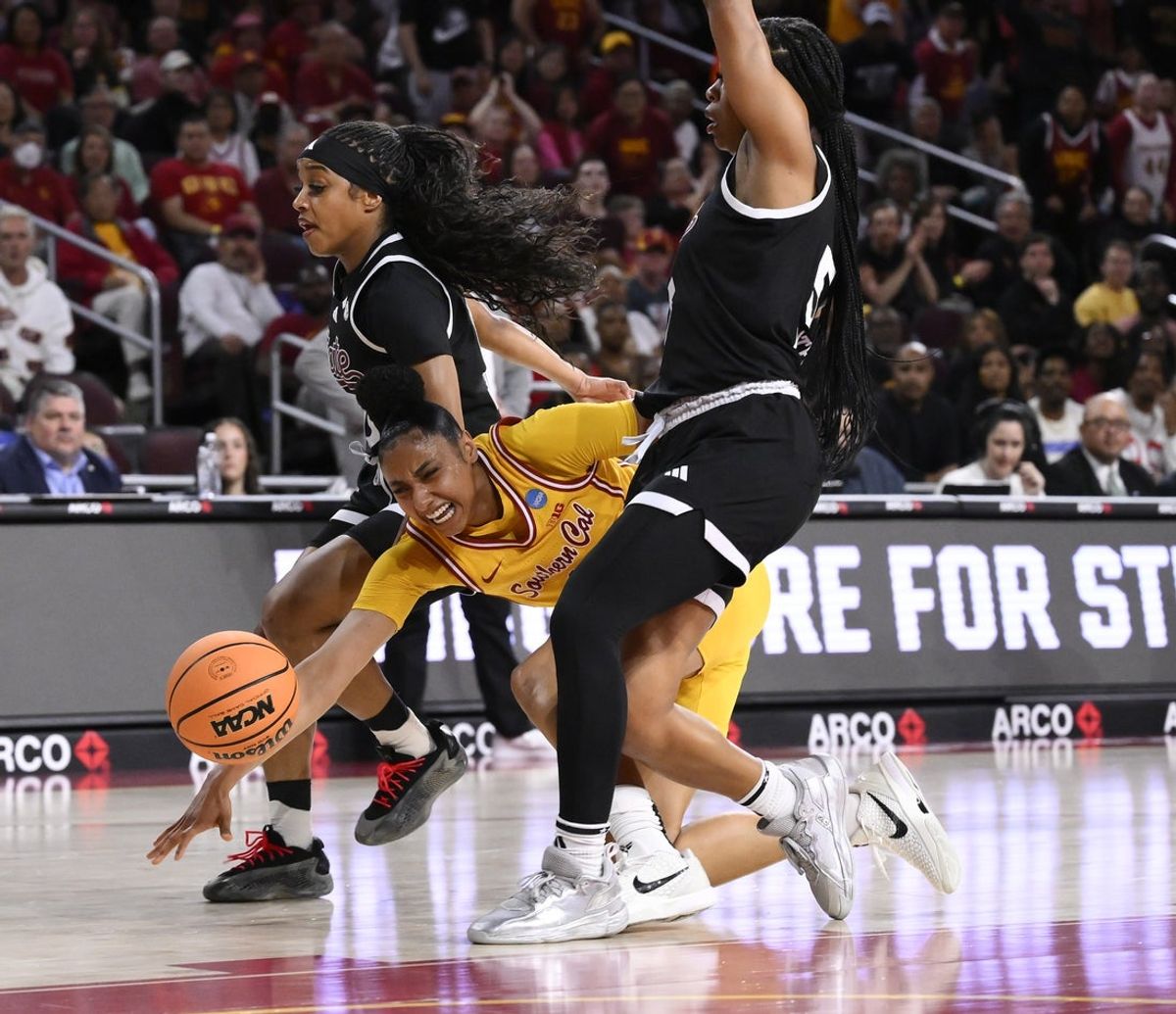 Mar 24, 2025; Los Angeles, California, USA; USC Trojans guard JuJu Watkins (12) injures her knee in the first quarter of an NCAA Tournament second round game against the Mississippi State Bulldogs at Galen Center. Mandatory Credit: Robert Hanashiro-Imagn Images