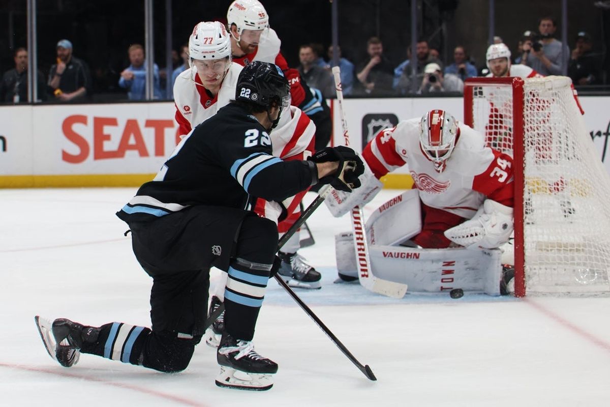 Mar 24, 2025; Salt Lake City, Utah, USA; Utah Hockey Club center Jack McBain (22) takes a shot on Detroit Red Wings goaltender Alex Lyon (34) during the third period at Delta Center. Mandatory Credit: Rob Gray-Imagn Images