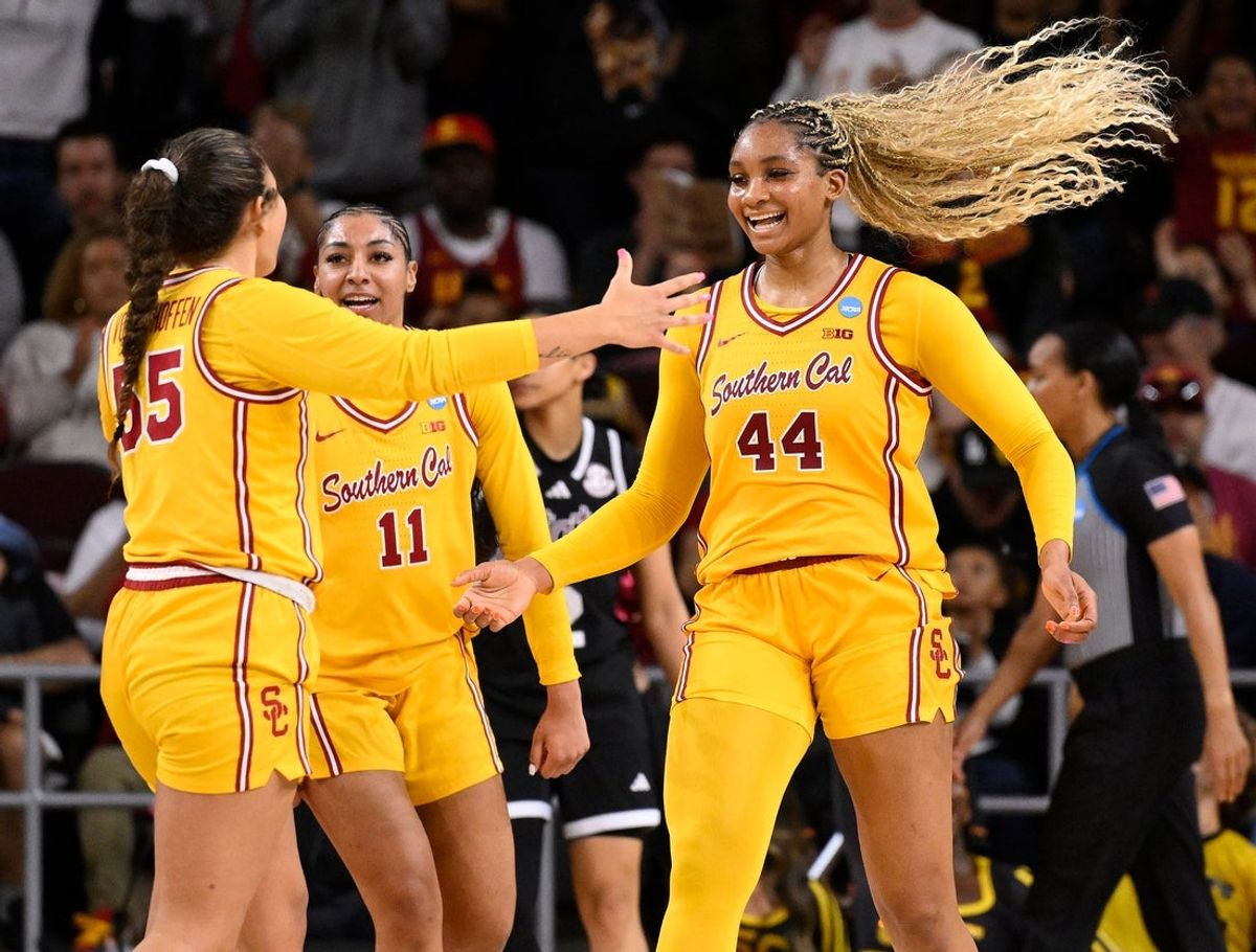 Mar 24, 2025; Los Angeles, California, USA; USC Trojans forward Kiki Iriafen (44) celebrates with Talia von Oelhoffen (55) and Kennedy Smith (11) after scoring in the third quarter against the Mississippi State Bulldogs during an NCAA Tournament second round game at Galen Center. Mandatory Credit: Robert Hanashiro-Imagn Images