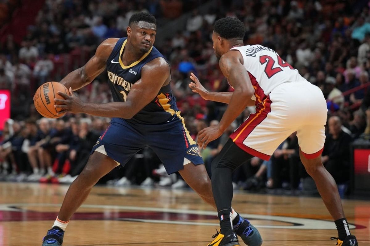 Mar 22, 2024; Miami, Florida, USA;  New Orleans Pelicans forward Zion Williamson (1) brings the ball up the court as Miami Heat forward Haywood Highsmith (24) during the first half at Kaseya Center.