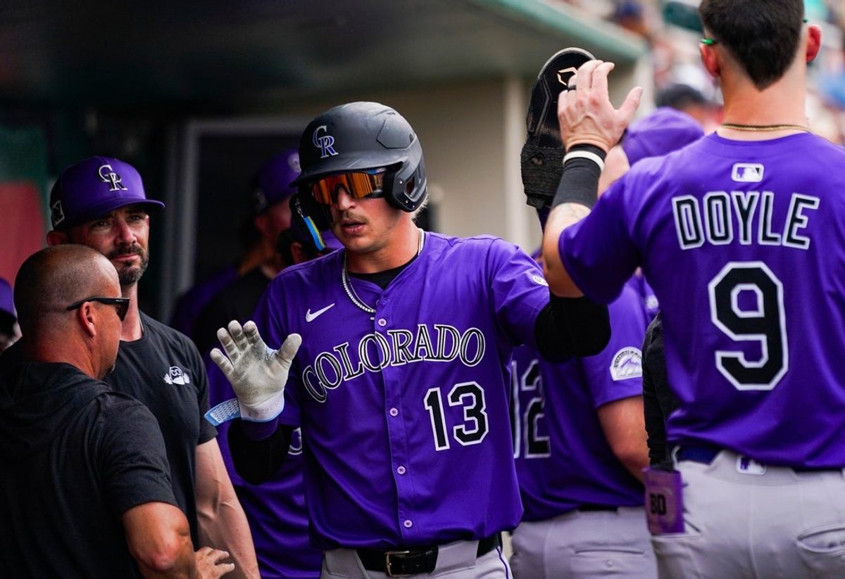 Colorado Rockies outfielder Zac Veen (13) celebrates after scoring during a spring training game against the Minnesota Twins at Lee Health Sports Complex in Fort Myers, Fla., on Tuesday, March 25, 2025.