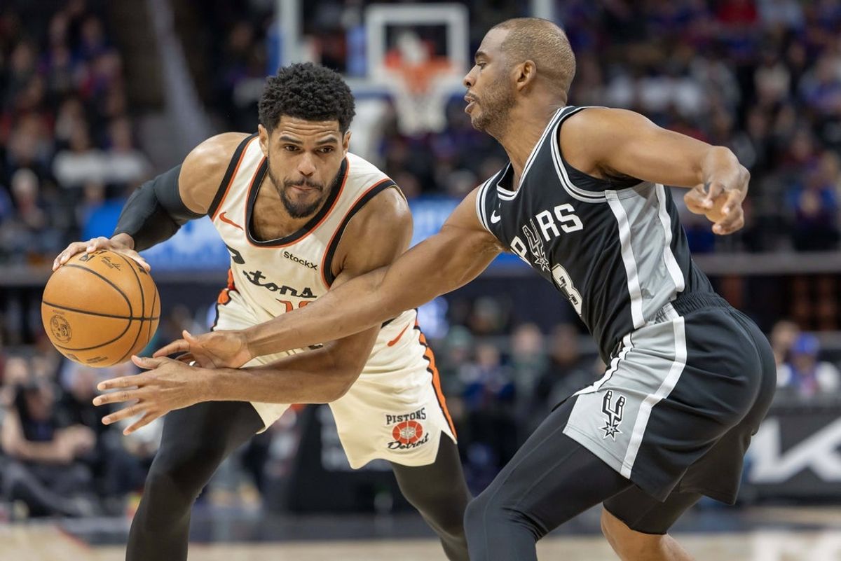 Mar 25, 2025; Detroit, Michigan, USA; San Antonio Spurs guard Chris Paul (3) defends against Detroit Pistons forward Tobias Harris (12) during the first half at Little Caesars Arena. Mandatory Credit: David Reginek-Imagn Images