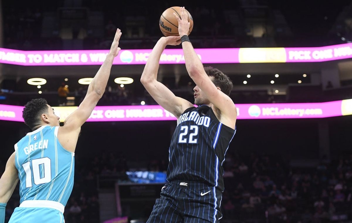 Mar 25, 2025; Charlotte, North Carolina, USA;  Orlando Magic forward Franz Wagner (22) shoots over Charlotte Hornets guard Josh Green (10) during the first half at the Spectrum Center. Mandatory Credit: Sam Sharpe-Imagn Images