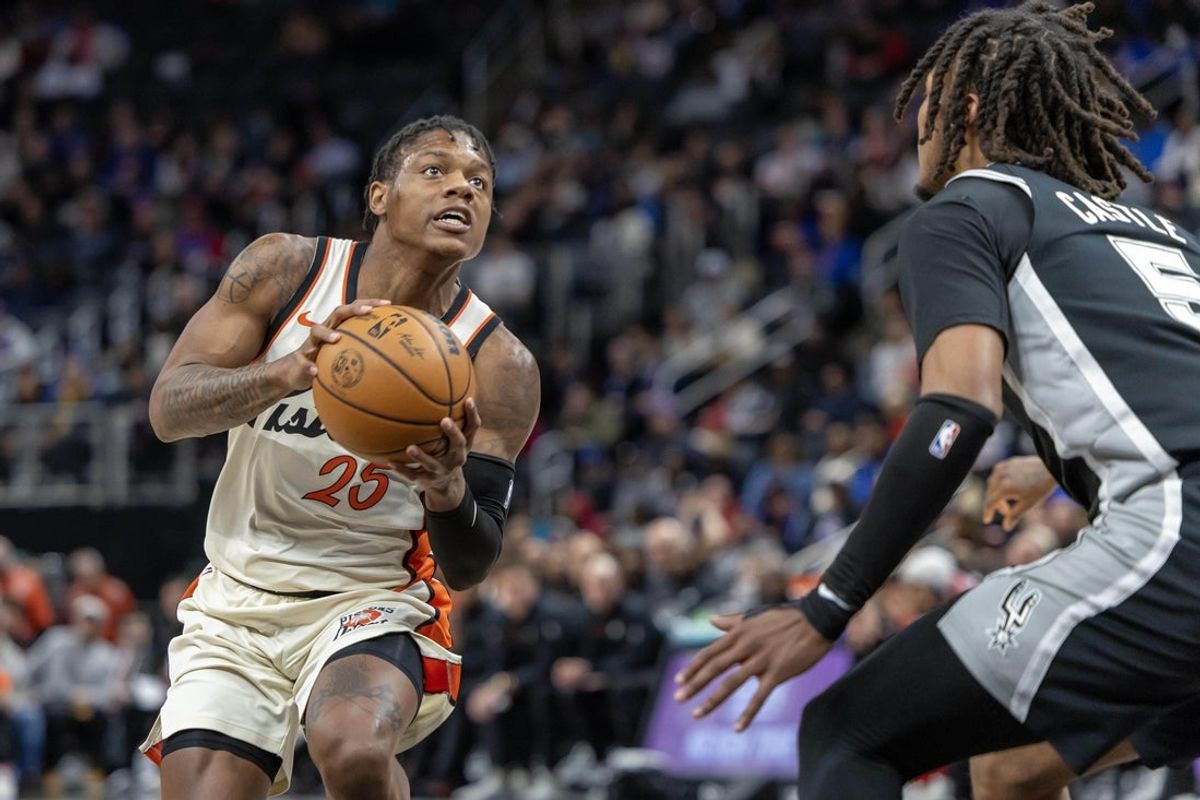 Mar 25, 2025; Detroit, Michigan, USA; Detroit Pistons guard Marcus Sasser (25) controls the ball in front of San Antonio Spurs guard Stephon Castle (5) during the first half at Little Caesars Arena. Mandatory Credit: David Reginek-Imagn Images