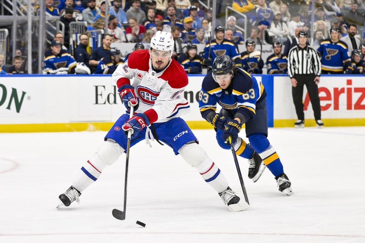 Mar 25, 2025; St. Louis, Missouri, USA;  Montreal Canadiens defenseman Arber Xhekaj (72) controls the puck as St. Louis Blues left wing Jake Neighbours (63) defends during the second period at Enterprise Center. Mandatory Credit: Jeff Curry-Imagn Images