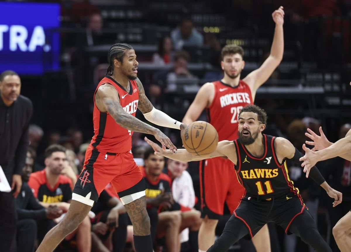 Mar 25, 2025; Houston, Texas, USA; Houston Rockets guard Jalen Green (4) passes the ball as Atlanta Hawks guard Trae Young (11) defends during the fourth quarter at Toyota Center. Mandatory Credit: Troy Taormina-Imagn Images
