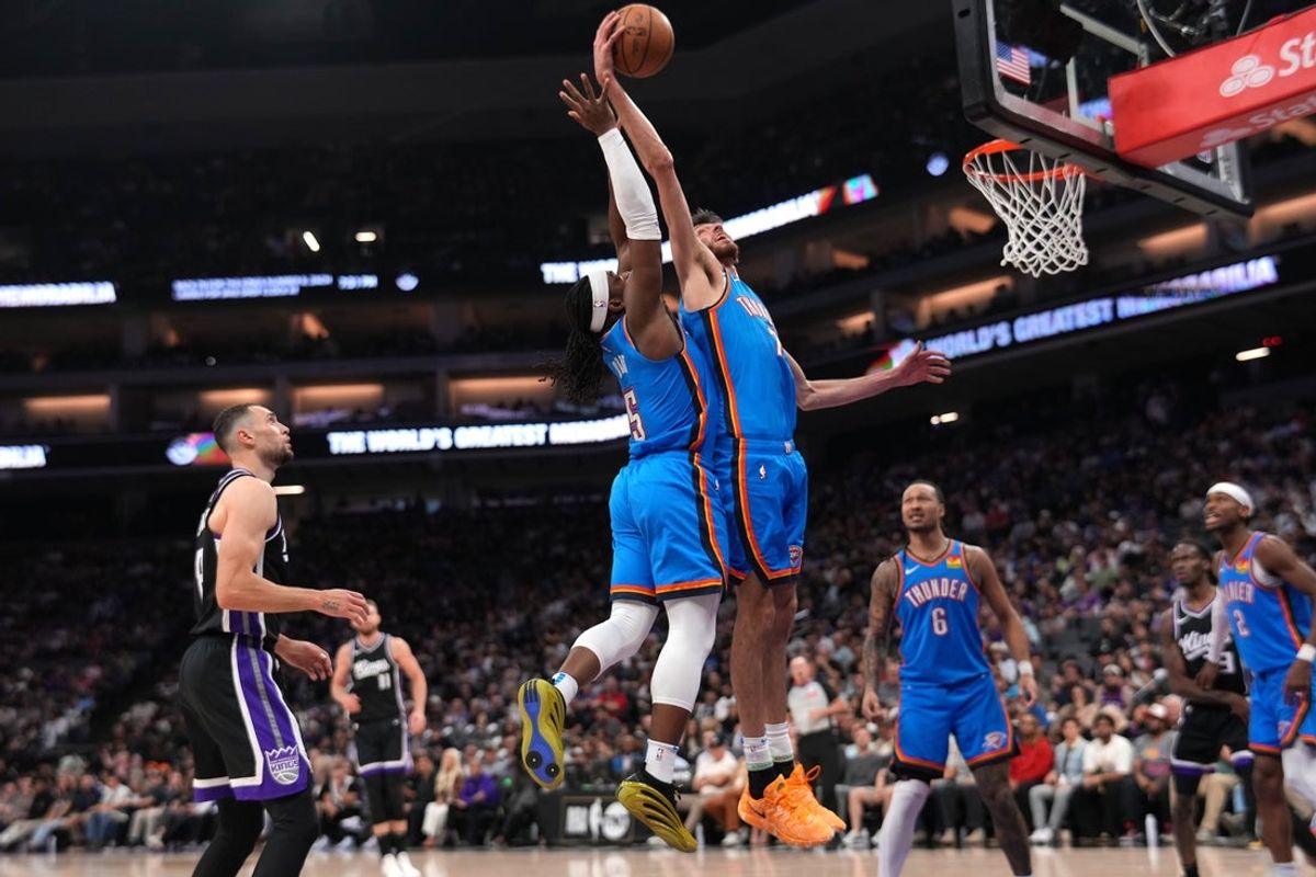 Mar 25, 2025; Sacramento, California, USA; Oklahoma City Thunder center Chet Holmgren (7) pulls down a rebound in front of guard Luguentz Dort (5) against the Sacramento Kings in the second quarter at the Golden 1 Center. Mandatory Credit: Cary Edmondson-Imagn Images