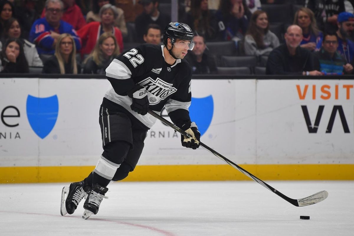 Mar 25, 2025; Los Angeles, California, USA; Los Angeles Kings left wing Kevin Fiala (22) moves the puck against the New York Rangers during the first period at Crypto.com Arena. Mandatory Credit: Gary A. Vasquez-Imagn Images